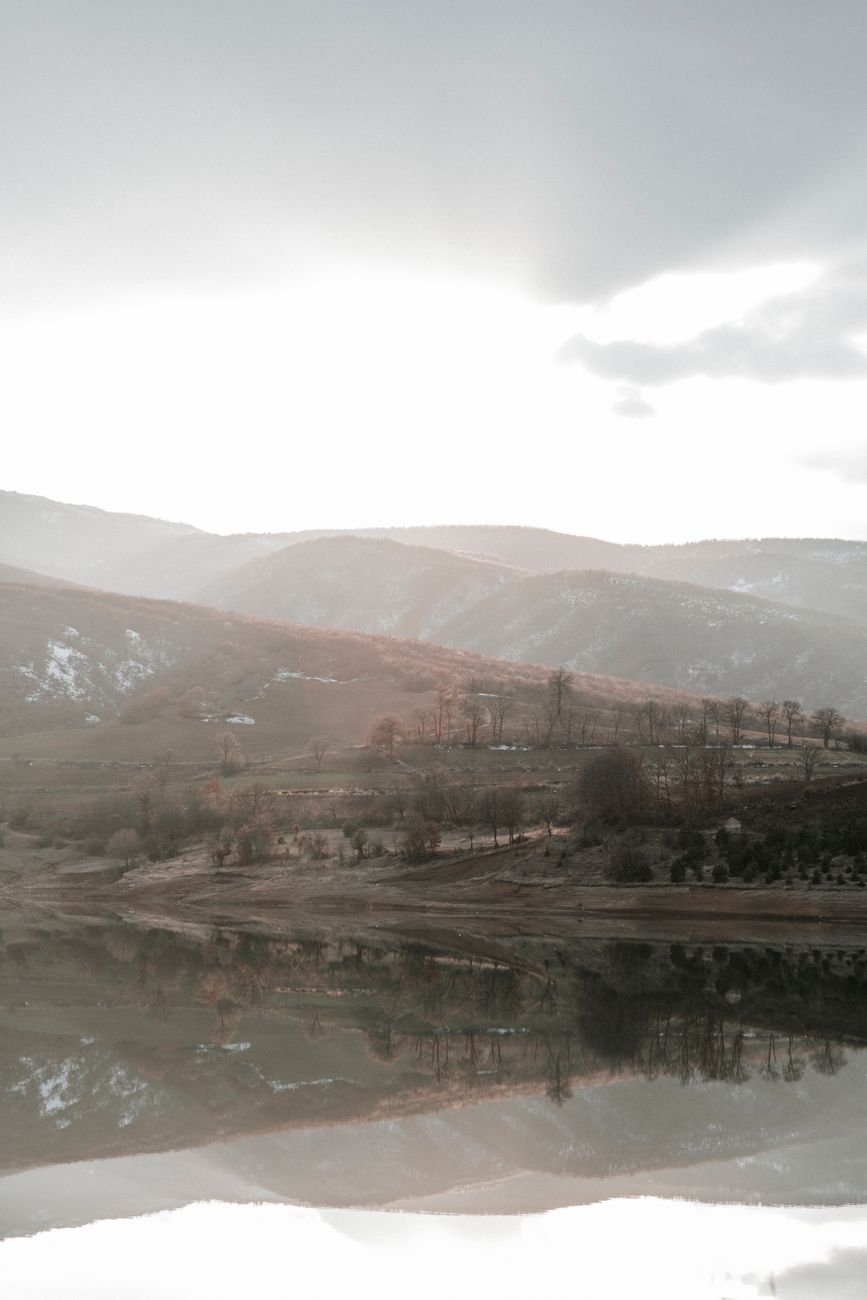 Majestic mountain range reflection in untouched alpine lake