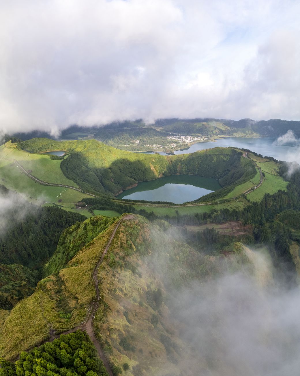 Lush volcanic landscape in the Azores with morning mist