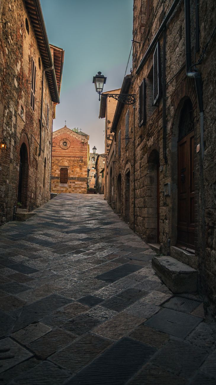 Ancient Italian cobblestone village street at golden hour